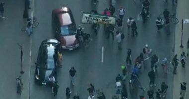 Car drives through anti-ICE protesters as Chicago joins nationwide anti-ICE unrest amid Trump crackdown
