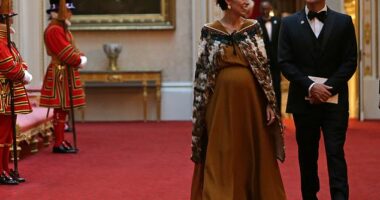 New Zealand Prime Minister Jacinda Ardern walks through Buckingham Palace with her husband Clarke Gayford on April 19, 2018. She was seven months pregnant at the time