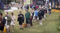 Glastonbury begins: Festivalgoers face rain, shower queues and hundreds of hippy crack canisters littering site after 'embarrassing sound issues' hit opening ceremony
