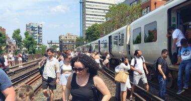 Heatwave hell as passengers are 'slow cooked' on stuck trains for hours amid 34C heat - as nation swelters on hottest day of the year