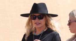 Holly Willoughby oozes festival chic in a leggy black mini dress and fedora as she leads the celebrities on the second day of sun-soaked Glastonbury