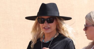 Holly Willoughby oozes festival chic in a leggy black mini dress and fedora as she leads the celebrities on the second day of sun-soaked Glastonbury