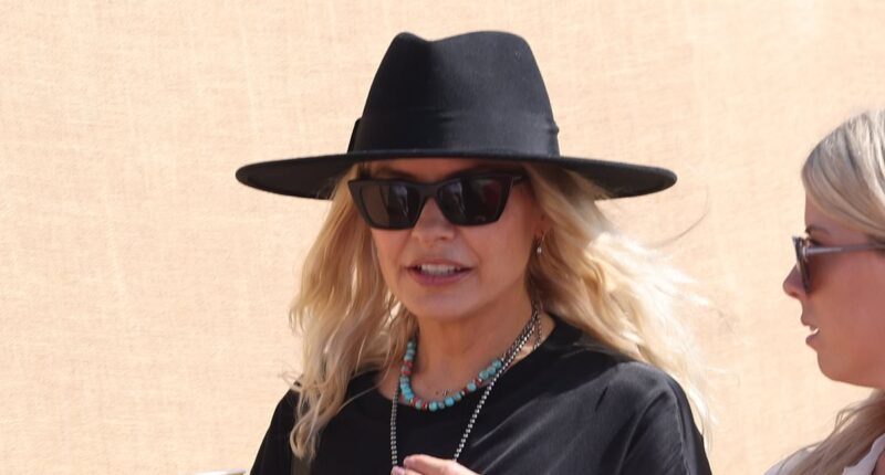 Holly Willoughby oozes festival chic in a leggy black mini dress and fedora as she leads the celebrities on the second day of sun-soaked Glastonbury