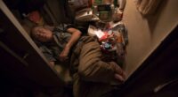 Hong Kong’s dystopian ‘coffin homes’ where 200,000 live in tiny boxes with barely enough space for a bed amid high rents