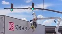 Horror moment worker is smashed into by huge 18-wheeler leaving him dangling from basket upside down above busy road