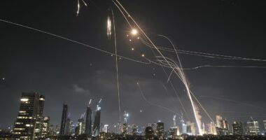 Iranian ballistic missiles rain down on Tel Aviv with skies ablaze after Iran vowed 'revenge' on Israel for nuclear site attacks