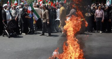 Iranians BURN US & Israel flags and chant ‘we want to DIE for Ayatollah’ as thousands join ‘death to the West’ protests