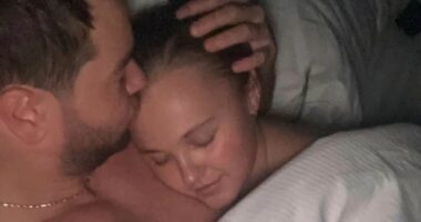 JoJo Siwa confirms she and Chris Hughes have made their romance official as she gushes she's 'head over heels' for him - after that steamy bedroom snap