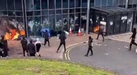 Leisure Centre 'being used as emergency accommodation for immigrants' goes up in flames after being set on fire by masked yobs: Riot cops swarm streets as Northern Ireland enters its third night of unrest 