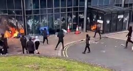 Leisure Centre 'being used as emergency accommodation for immigrants' goes up in flames after being set on fire by masked yobs: Riot cops swarm streets as Northern Ireland enters its third night of unrest 