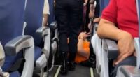 Moment bulky passenger who demanded aisle seat for his big frame is DRAGGED off jet wearing ‘too busy doing nothing’ top