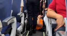 Moment bulky passenger who demanded aisle seat for his big frame is DRAGGED off jet wearing ‘too busy doing nothing’ top