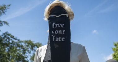 Moment crowd of women's rights campaigners dressed in Niqab-style veils ripped them off to declare 'free your face' in provocative London protest