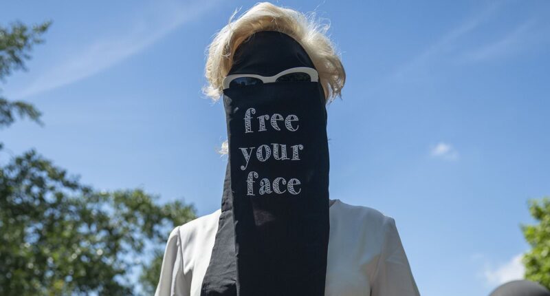Moment crowd of women's rights campaigners dressed in Niqab-style veils ripped them off to declare 'free your face' in provocative London protest