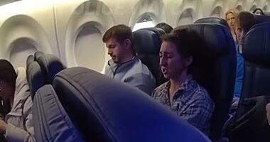 Moment drunk passenger is hauled off flight by cops after necking six wines as ENTIRE plane is forced to disembark