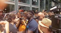 Moment furious hotel worker fights back against crowd of anti-tourism protesters as they seal off his business in Barcelona and bombard it with water guns and smoke canisters