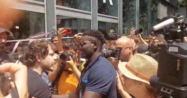 Moment furious hotel worker fights back against crowd of anti-tourism protesters as they seal off his business in Barcelona and bombard it with water guns and smoke canisters