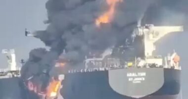 Moment huge flames leap from cargo ship as ‘dark fleet’ tanker burns at sea after being ‘hit by another boat’