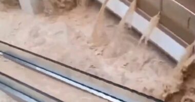 Shock moment floods swamp shopping centre turning escalators into waterfalls & washing cars into underground garages