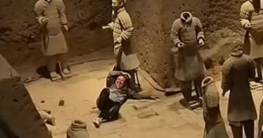 Shock moment tourist jumps railing and plunges 18ft into Terracotta Army pit before smashing two priceless statues