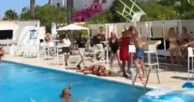 Shocking moment female tourist is bashed in the head with a CHAIR while another topples into pool in Ibiza hotel brawl