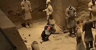 Shocking moment tourist jumps into Terracotta Army clay warriors and damages statues before being overpowered by security guards