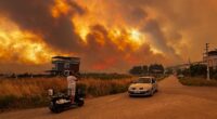 Travel chaos as wildfires tear through holiday hotspot and grounds flights leaving 100s of passengers stranded as Europe scorches... and Britain is set to hit record-breaking temperatures