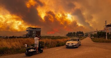Travel chaos as wildfires tear through holiday hotspot and grounds flights leaving 100s of passengers stranded as Europe scorches... and Britain is set to hit record-breaking temperatures