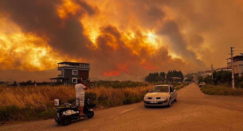 Travel chaos as wildfires tear through holiday hotspot and grounds flights leaving 100s of passengers stranded as Europe scorches... and Britain is set to hit record-breaking temperatures