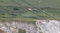 Two dead after car plunges 300ft off cliff at beauty spot 'as horrified holidaymakers watched on'