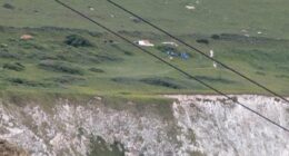 Two dead after car plunges 300ft off cliff at beauty spot 'as horrified holidaymakers watched on'